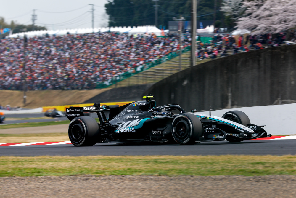 Mercedes F1 car speeding on track in the distance